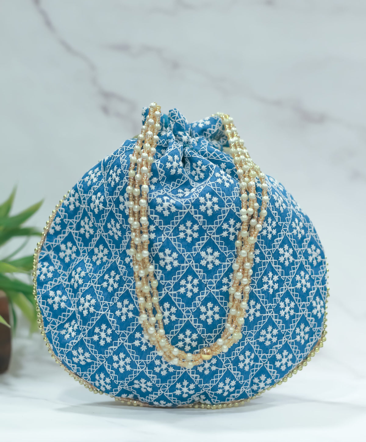 Cross embroidered potli with pearl handle