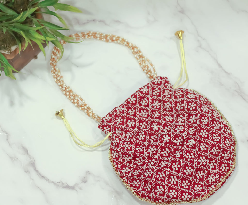 Cross embroidered potli with pearl handle