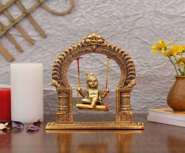 Baby Krishna on jhula statue