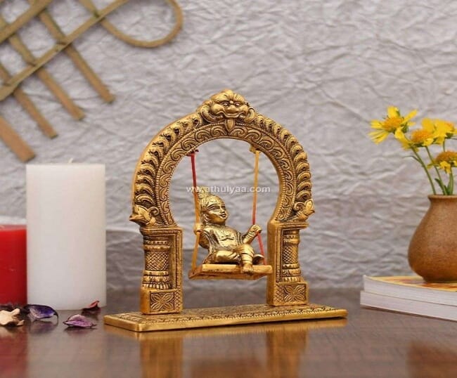 Baby Krishna on jhula statue