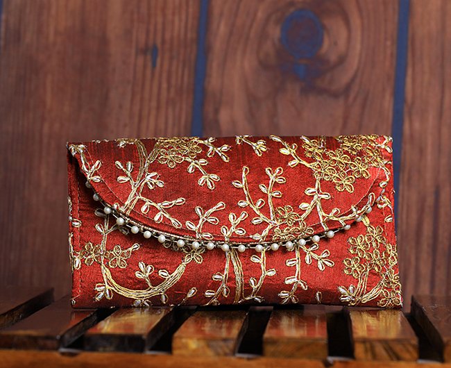 Golden embroidered flap clutch